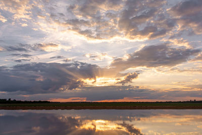 Sunset on the lake. beautiful sunset behind the storm clouds before a thunder storm