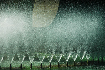 Water drops on glass against sky