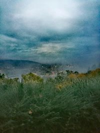 Scenic view of calm sea against cloudy sky