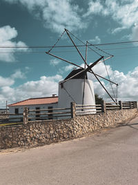 Low angle view of electricity pylon against sky