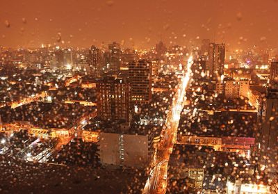 Aerial view of city lit up at night