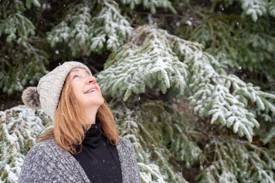 Portrait of smiling young woman in snow