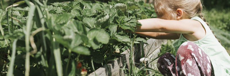 Midsection of woman standing by plants