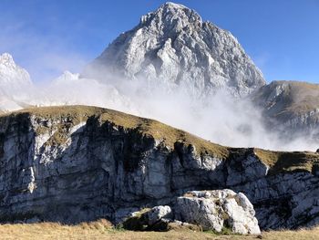 Scenic view of snowcapped mountains against sky in mangart - slovenia