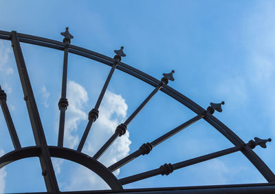 Low angle view of silhouette chain against sky