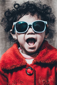 Portrait of boy wearing sunglasses at home