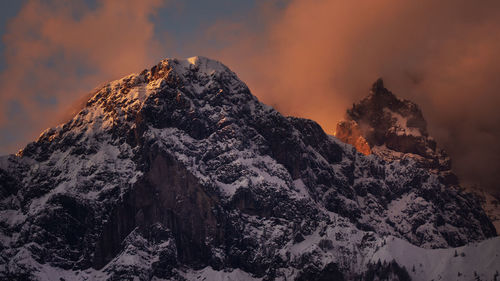 Scenic view of snowcapped mountains against sky during sunset 