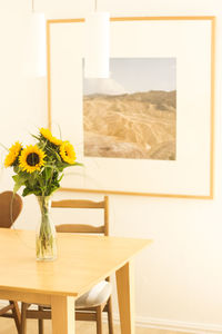 Close-up of yellow vase on table at home