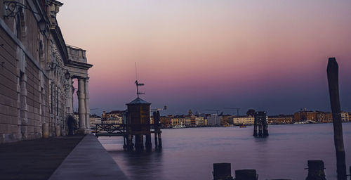 View of buildings in city at sunset