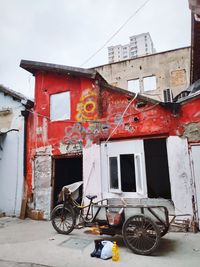 Bicycle on old building against sky