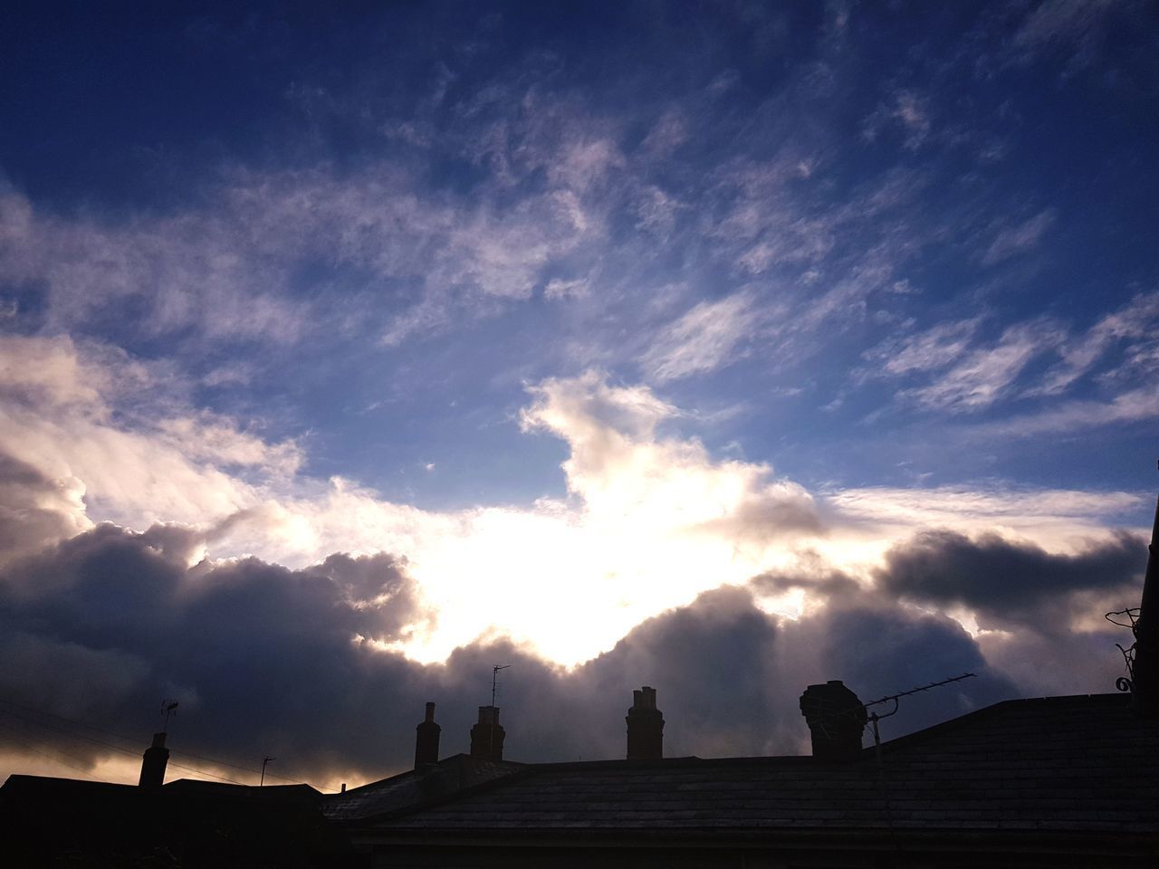 LOW ANGLE VIEW OF SILHOUETTE PEOPLE AGAINST SKY