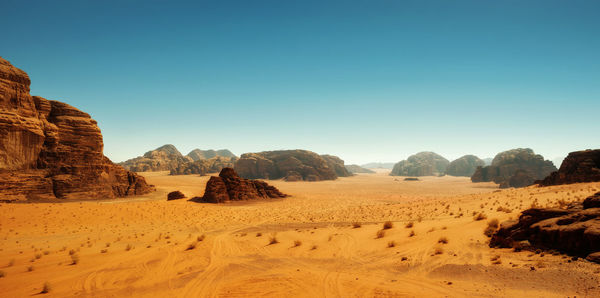 Scenic view of desert against clear sky