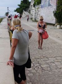 People walking on footpath in city