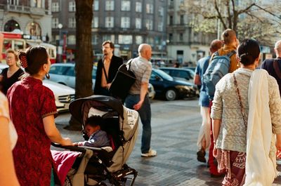 Rear view of people walking in city