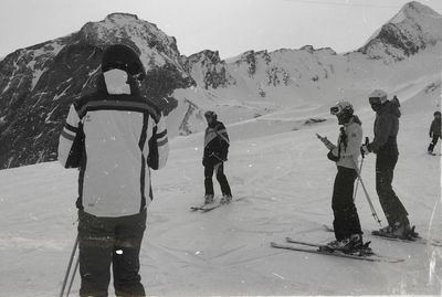 People skiing on snow covered mountain