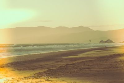 Scenic view of beach against sky during sunset