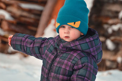 Portrait of cute boy wearing warm clothing outdoors