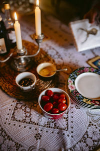 High angle view of candles and food on table