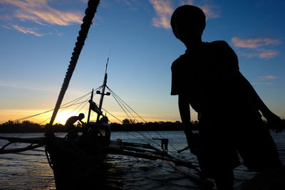 People in water at sunset