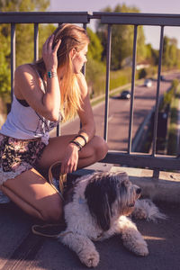 Woman with dog sitting outdoors