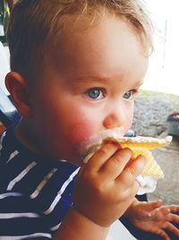 Close-up of cute boy eating waffle ice cream