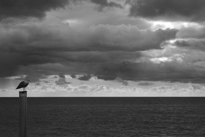 Scenic view of sea against storm clouds