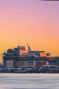 Buildings in city at sunset