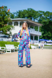 Full length of young woman standing outdoors