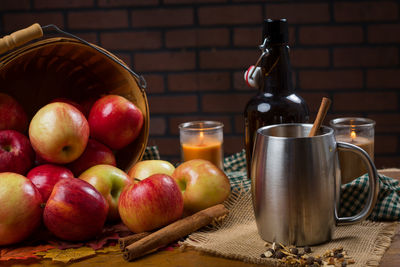 Close-up of fruits by drink on table