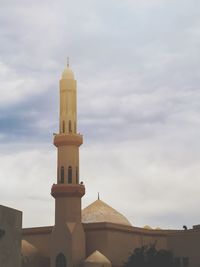 Low angle view of tower amidst buildings against sky