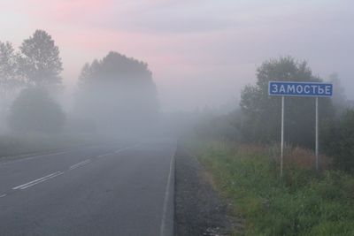 Road amidst trees against sky