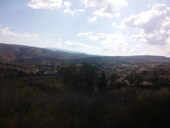 Scenic view of mountains against cloudy sky