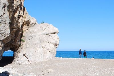 Rear view of two people  contemplating the sea