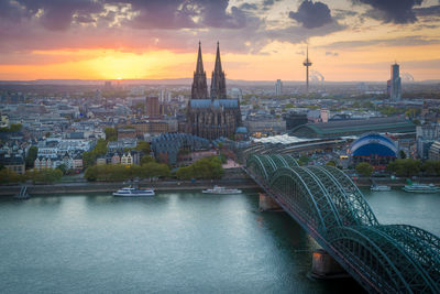 Bridge over river against buildings in city