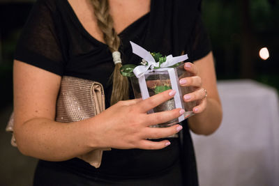 Midsection of woman holding gift