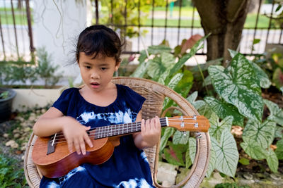 Girl playing ukulele 