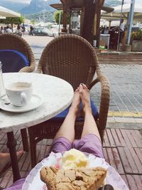 Midsection of woman sitting at restaurant table