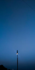 Low angle view of street light against clear blue sky