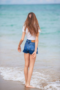 Young woman standing at beach