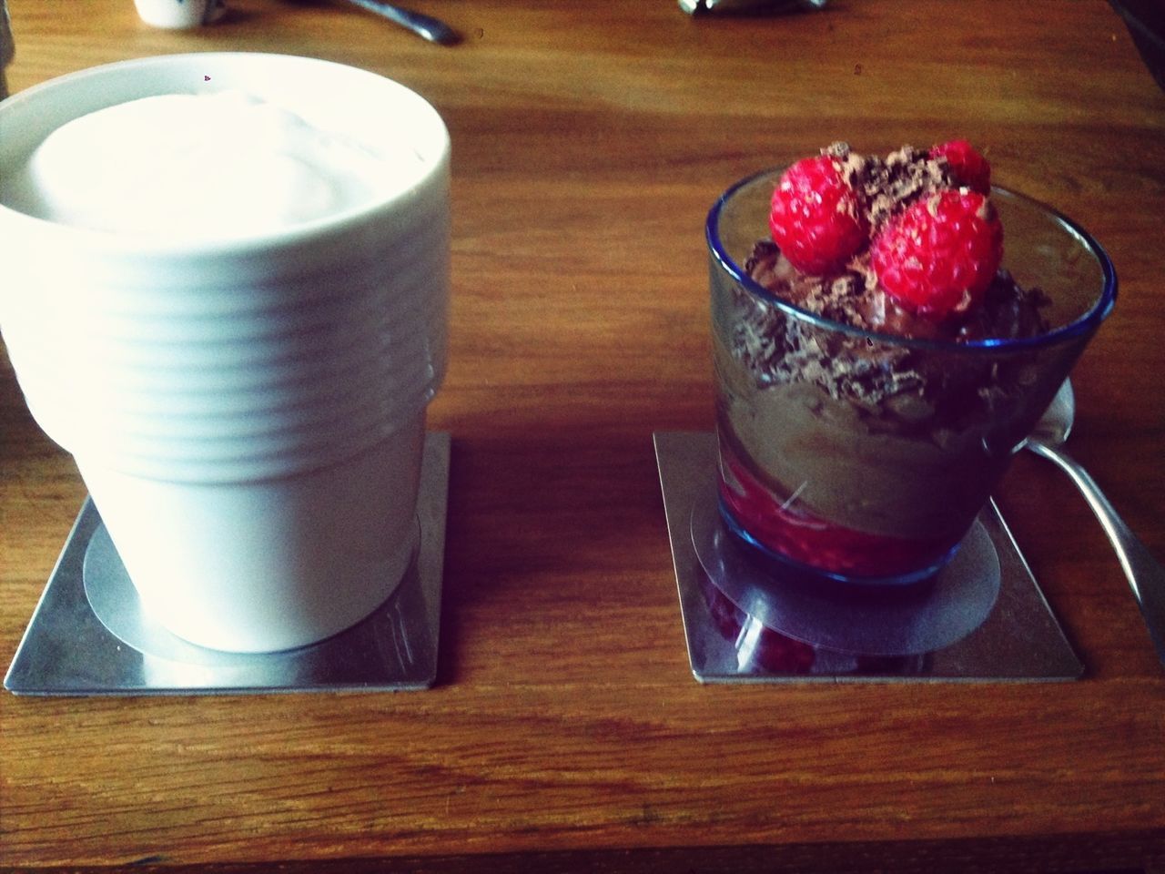 indoors, food and drink, freshness, table, still life, food, high angle view, drink, sweet food, refreshment, wood - material, healthy eating, plate, dessert, drinking glass, fruit, ready-to-eat, close-up, bowl, indulgence