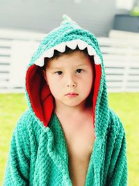 Portrait of boy wearing bathrobe outdoors