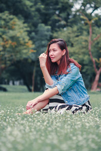 Portrait of young woman sitting outdoors