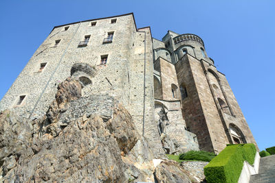 Low angle view of old building against blue sky