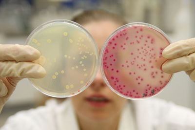 Close-up of hands holding lab glass 