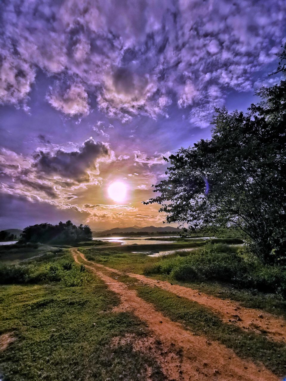 SCENIC VIEW OF LAND AGAINST SKY DURING SUNSET