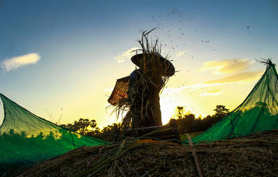 Low angle view of man on field against sky