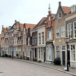 Buildings in city against clear sky