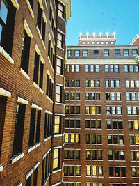 Low angle view of buildings in city against sky