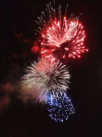 Low angle view of firework display at night