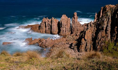 Panoramic view of rocks on beach against sky